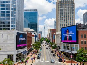 A view of a bustling Atlanta street with digital marketing advertisements.