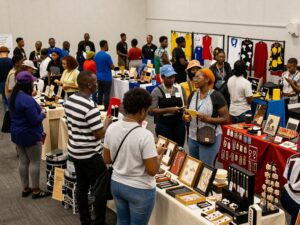 A diverse crowd engaging with exhibitors at the Atlanta Black Expo.