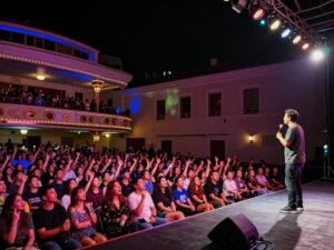 Audience enjoying a comedy performance at the Atlanta Symphony Hall