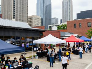 A vibrant Atlanta cityscape with small businesses and community gatherings.