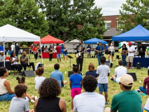 A lively community gathering in Atlanta with music and families enjoying their time.