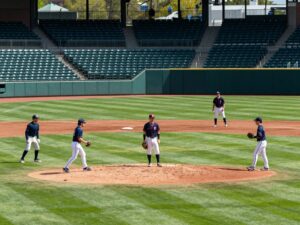 Spring training scene at a baseball field with players preparing for the season.