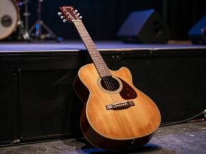 Vintage guitar on a stage representing rock band legacy
