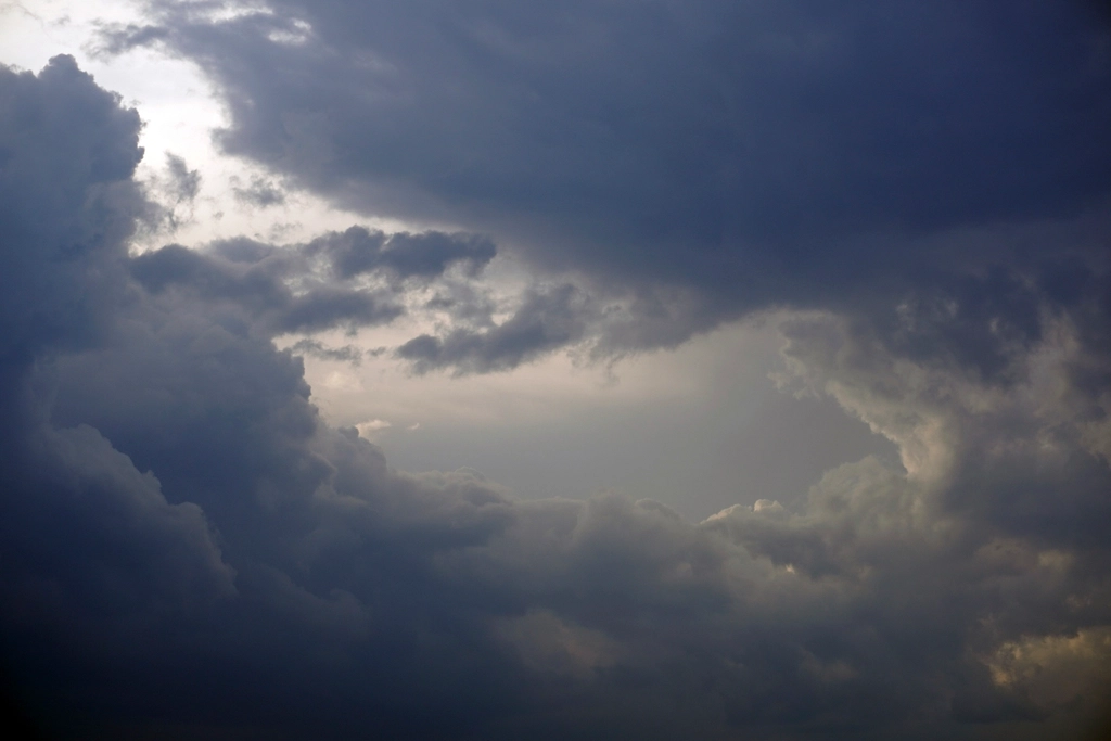 Dark storm clouds gathering over city skyline